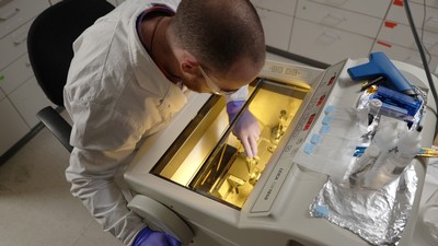 Image shows Bailey McFarland working with a Leica Cryostat.